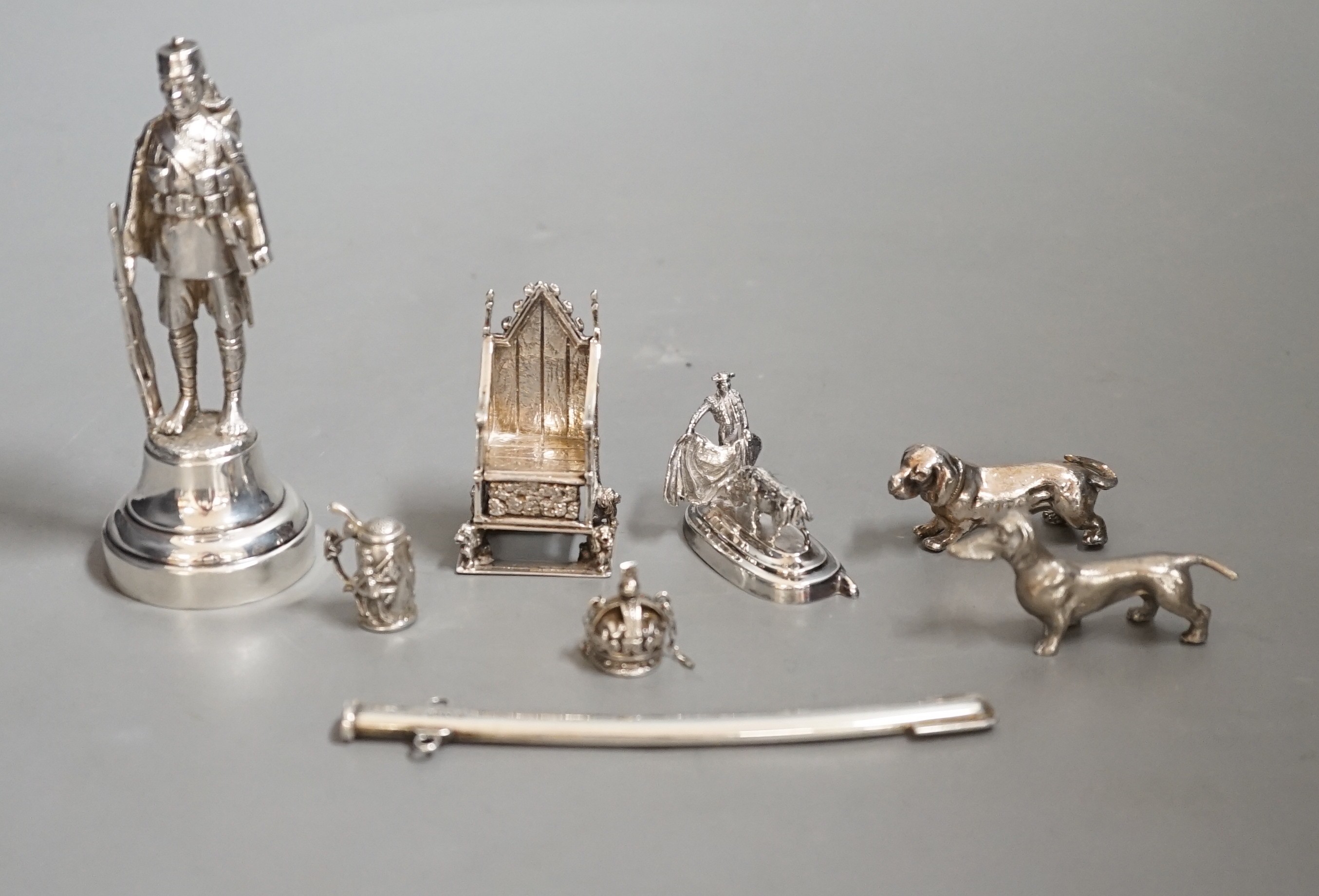 A group of novelty miniature silver items to include a sword, a solider by Goldsmiths & Silversmiths Co Ltd, London, 1930, 10.5cm, a throne, a matador figure, etc.